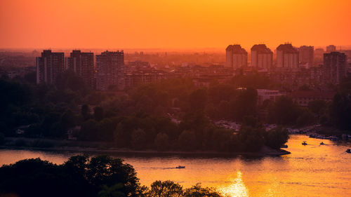 Buildings in city during sunset