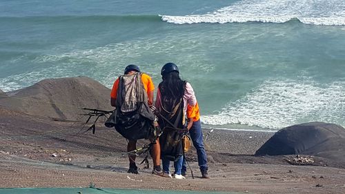 Rear view of people on sea shore