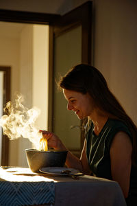 Young woman and had food with steam 