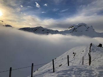 Scenic view of snow covered mountains against sky