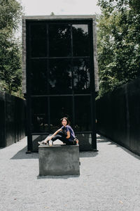 Full length of senior man sitting in yard