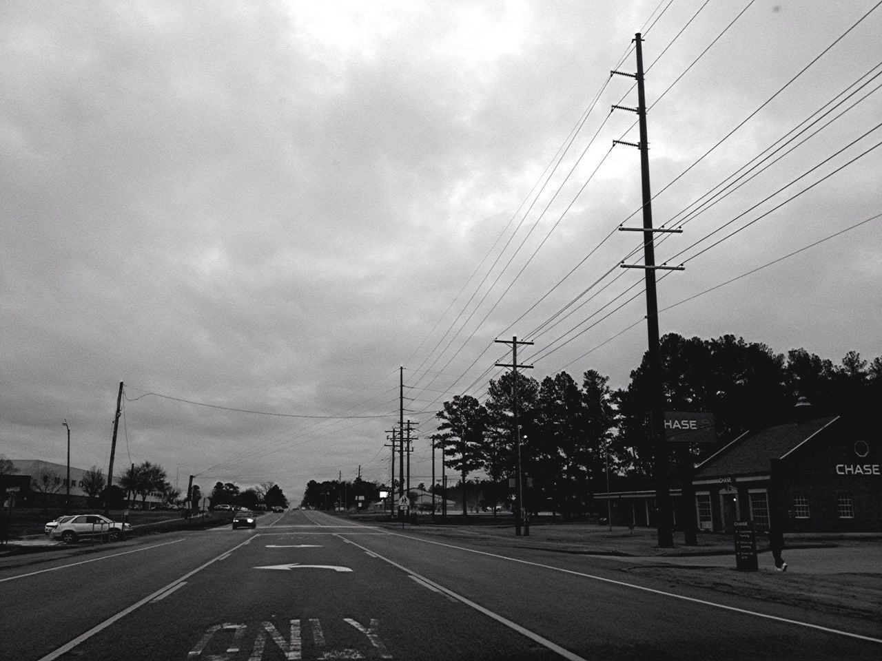 electricity pylon, power line, transportation, sky, road, the way forward, power supply, electricity, cloud - sky, cable, connection, street, cloudy, road marking, fuel and power generation, diminishing perspective, tree, car, cloud, power cable