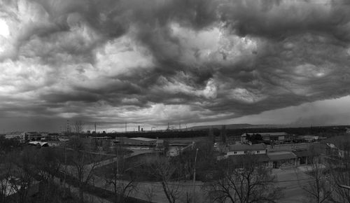 High angle view of buildings against cloudy sky