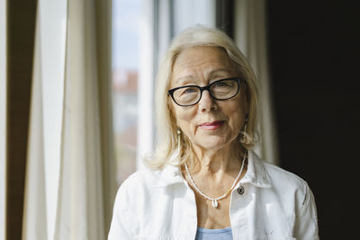 Smiling senior woman wearing eyeglasses at home