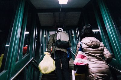 Low angle view of people climbing steps at railroad station