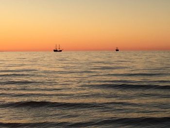 Scenic view of sea against orange sky