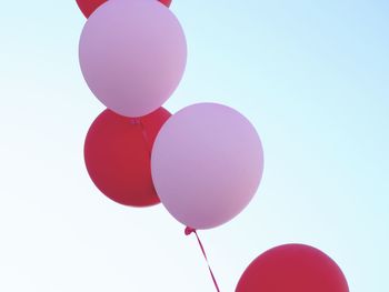 Low angle view of balloons against sky