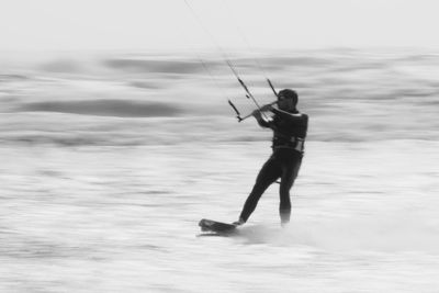 Man kiteboarding on sea