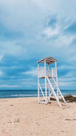 Lifeguard hut on beach against sky