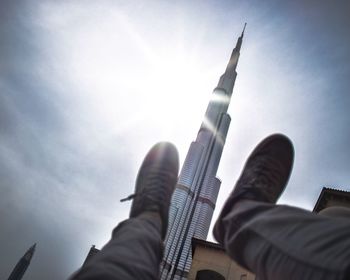 Low angle view of hand against sky