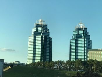 View of skyscrapers against clear blue sky