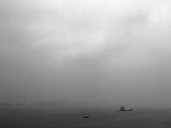 Boat sailing in sea against sky