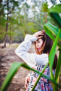 Portrait of beautiful woman standing on land