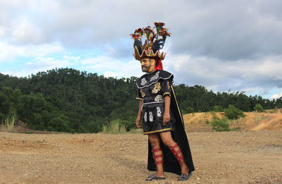 Person standing on field against sky