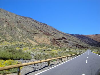 Scenic view of mountains against clear blue sky