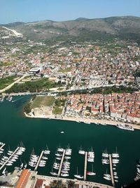 High angle view of buildings by harbor in city