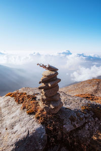 Stack of rocks on shore against sky