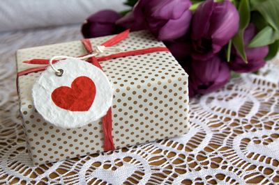 Close-up high angle view of gift with flowers on table