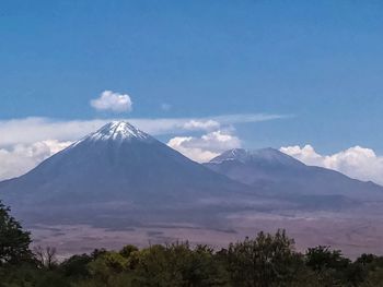Scenic view of snowcapped mountains against cloudy sky