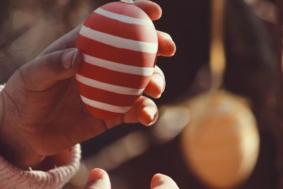 Cropped image of hand holding easter egg