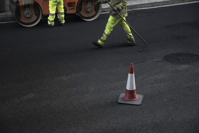 Low section of man standing on road