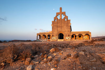 Abandoned abades church frontal in the magnificent light of sunrise.