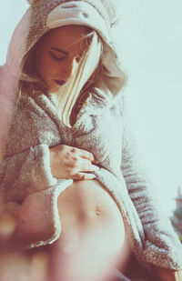 Midsection of woman looking at camera