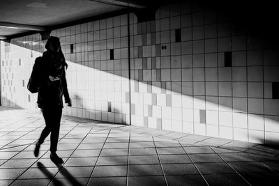 Rear view of woman walking on staircase