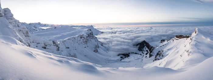 Scenic view of snow covered mountains against sky