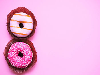 High angle view of cupcakes against pink background
