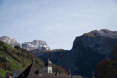 Panoramic view of houses and mountains against sky