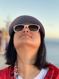 Close-up of woman wearing sunglasses looking up