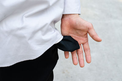 Midsection of man showing empty pocket on road