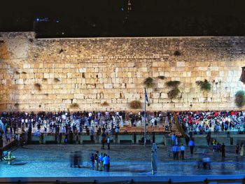 High angle view of people playing soccer against built structure