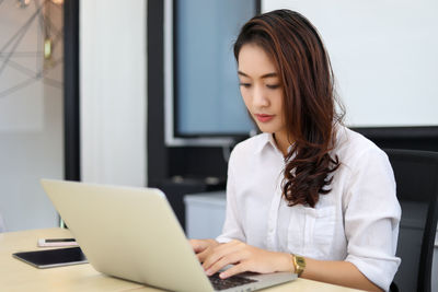 Young woman using laptop at home