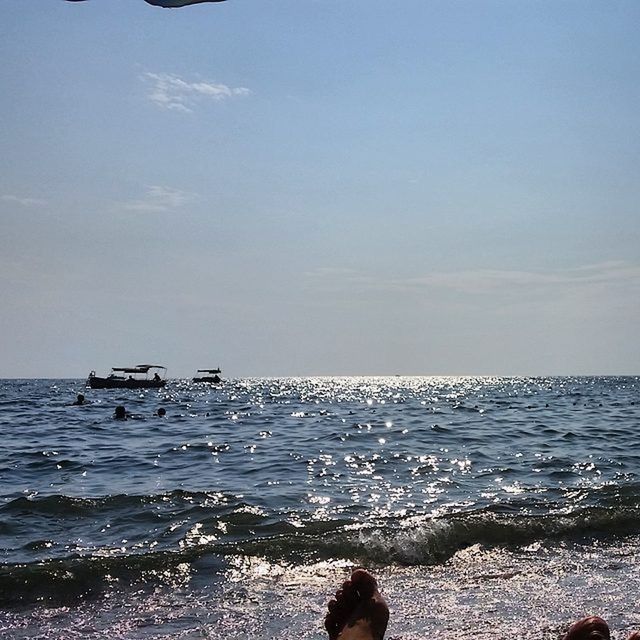 sea, water, horizon over water, nautical vessel, sky, scenics, beach, transportation, beauty in nature, mode of transport, nature, tranquility, tranquil scene, boat, wave, shore, men, leisure activity, idyllic