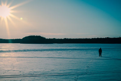 Person walking on snow covered field