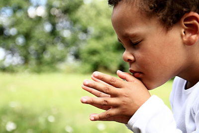 Close-up portrait of boy with hands