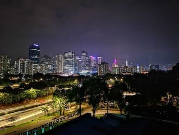 Illuminated cityscape against sky at night