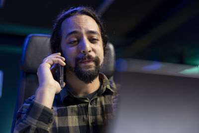 Portrait of young man using mobile phone