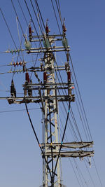 Electricity pylon against clear sky