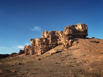 Low angle view of rock formations against sky