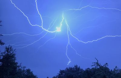 Low angle view of lightning against sky at night
