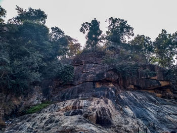 Low angle view of rocks on land against sky