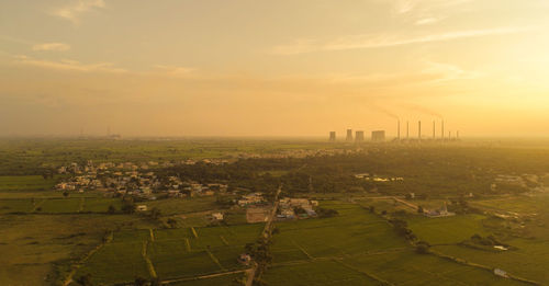 High angle view of agricultural field against sky during sunset