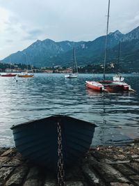 Sailboats moored in bay