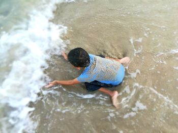 High angle view of man surfing in sea