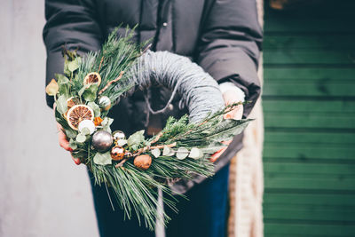 Midsection of woman holding bouquet