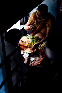 Young woman eating food at home