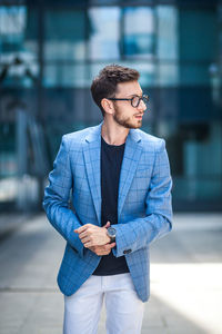 Young man looking away in city